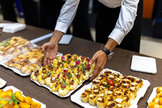 Quiet buffet spread with sandwiches, fruit, and refreshments at memorial gathering