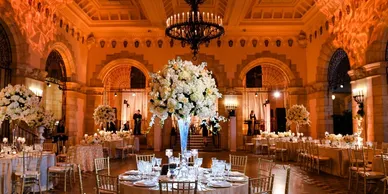 Catering vendor arranging chafing dishes on a buffet table at venue